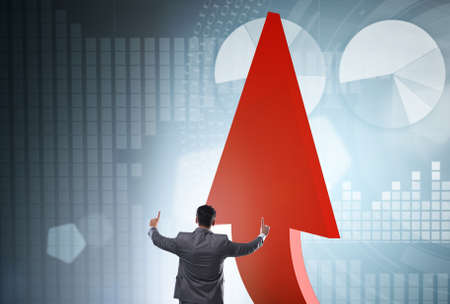The businessman supporting growtn in economy on chart graph