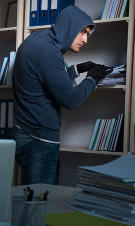 Young man in industrial espionage conceptの写真素材