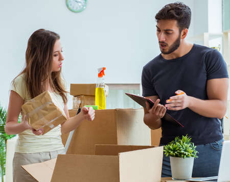 Young family unpacking at new house with boxesの写真素材