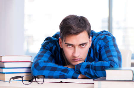 Student studying in the empty library with book preparing for exの写真素材