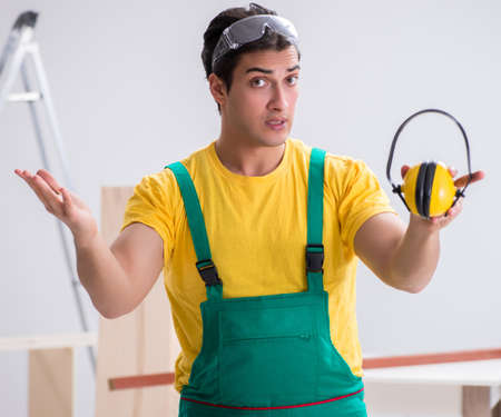 Worker showing the importnace of wearing noise cancelling headphの写真素材