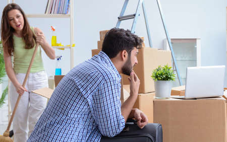 The young family unpacking at new house with boxesの写真素材