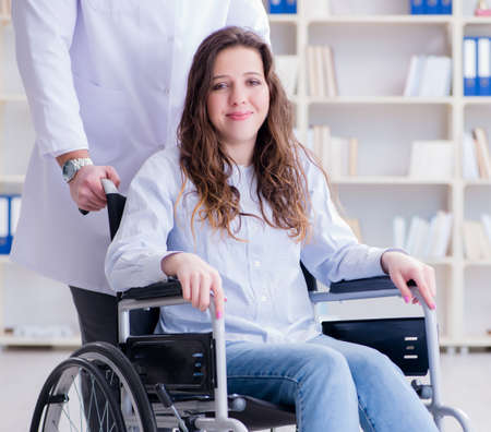 Disabled patient on wheelchair visiting doctor for regular checkの写真素材