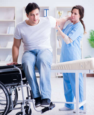 Patient undergoing rehabilitation recovery programme with doctorの写真素材