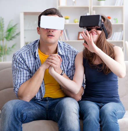 Young family playing games with virtual reality glassesの写真素材
