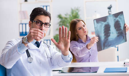 Doctor examining x-ray images of patientの写真素材