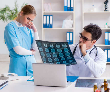 The two doctors examining x-ray images of patient for diagnosis