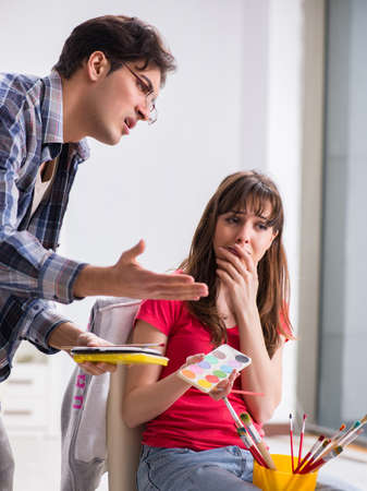 The artist coaching student in painting class in studioの写真素材