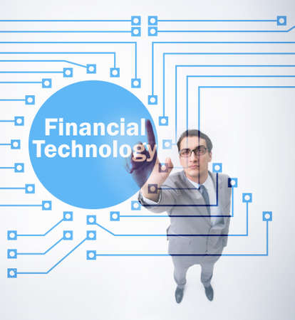 Businessman pressing buttons in fintech conceptの写真素材