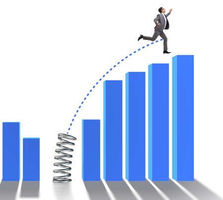 Business people jumping over bar charts