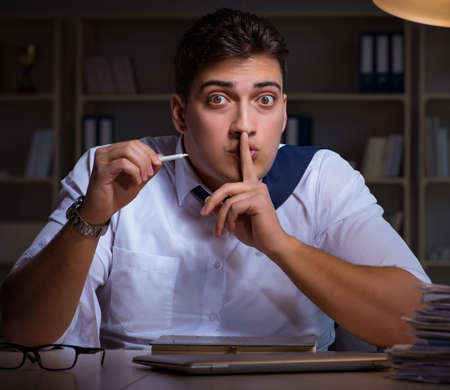 Man staying late at night and smoking marijuanaの写真素材
