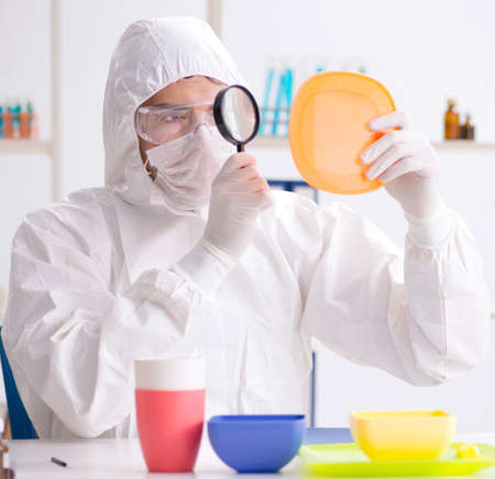 Chemist checking and testing plastic dishesの写真素材