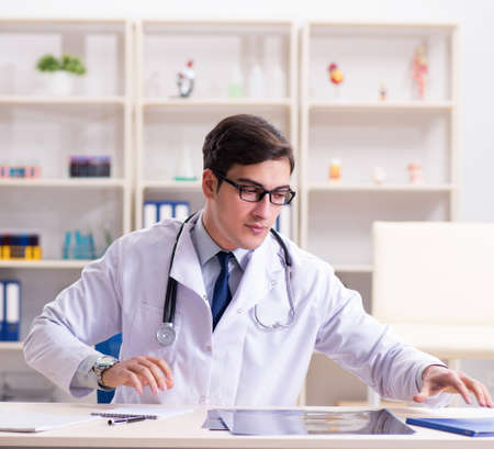 Young doctor sitting in the officeの写真素材