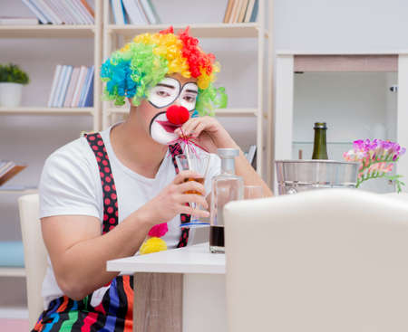 Drunk clown celebrating having a party at homeの写真素材