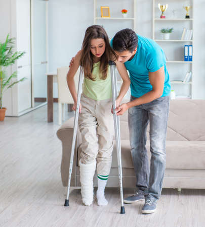 Husband man supporting injured wifeの写真素材