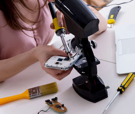 Mobile phone repair in workshopの写真素材