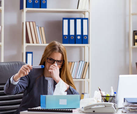 Businesswoman employee sick in the officeの写真素材