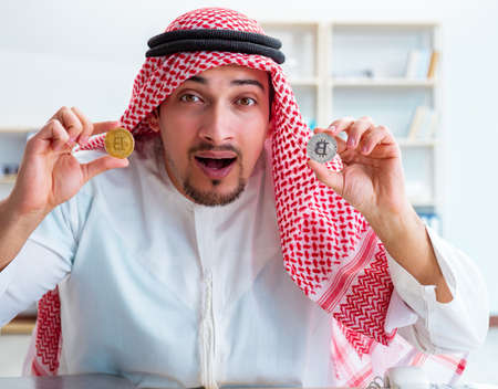 Arab man with bitcoin in cryptocurrency mining conceptの写真素材