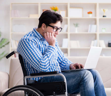 Young student on wheelchair in disability conceptの写真素材