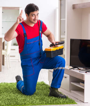 Professional repair engineer repairing broken tvの写真素材