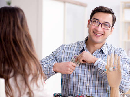 Woman visiting jeweler for jewelery evaluationの写真素材