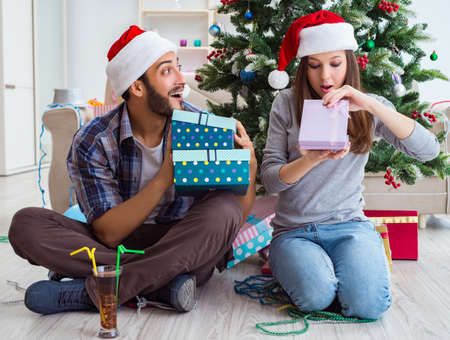 Girlfriend and boyfriend opening christmas giftsの写真素材