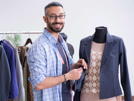 Male tailor working in the workshop on new designs