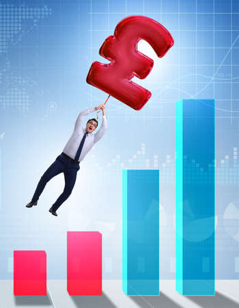 The businessman flying on british pound sign inflatable balloonの写真素材