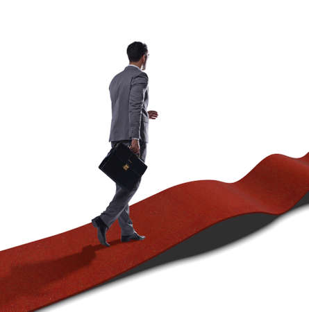 The businessman on red carpet isolated white backgroundの写真素材