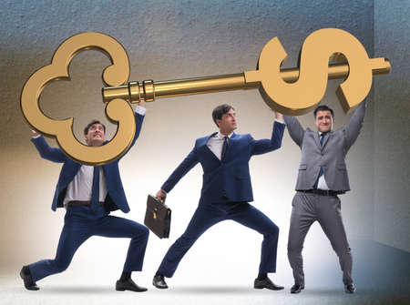 Businessmen with dollar key unlocking doorの写真素材