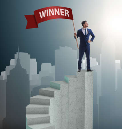 Businessman winner on top of staircaseの写真素材