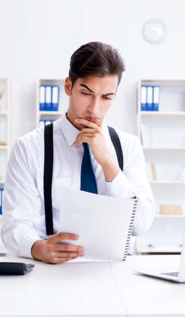 Young stylish businessman working in the officeの写真素材