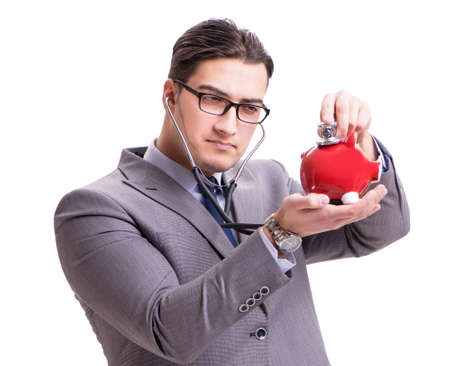 Businessman with stethoscope and piggybank isolated white backgrの写真素材