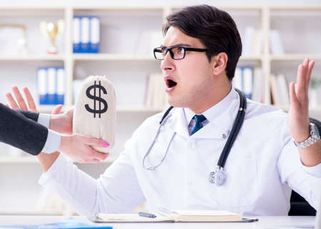 Young doctor in medical insurance fraud conceptの写真素材