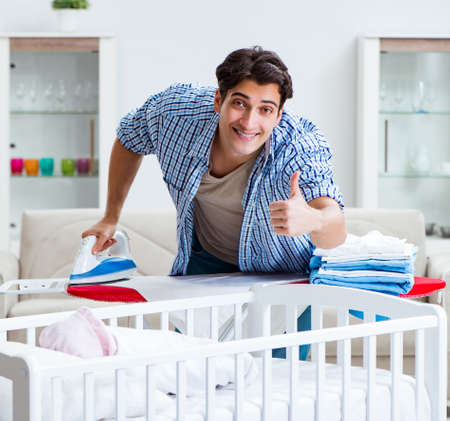 The young dad looking after newborn babyの写真素材