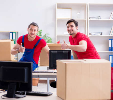 Two contractor employees moving personal belongingsの写真素材