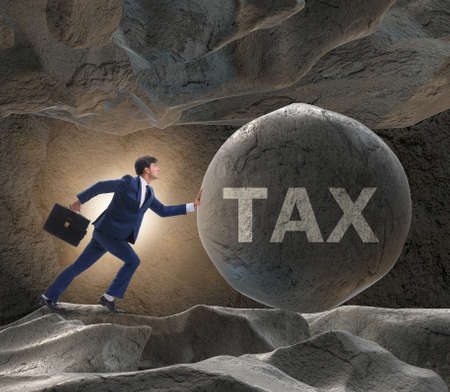 Businessman in high taxes business conceptの写真素材