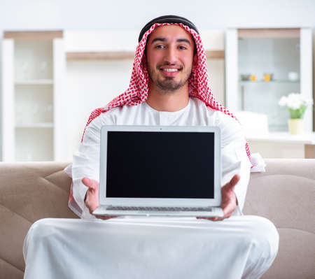 Arab man working at home on his workの写真素材
