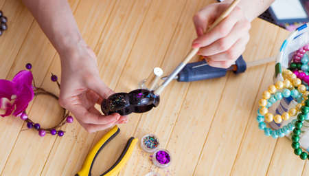 Woman making jewelry at home