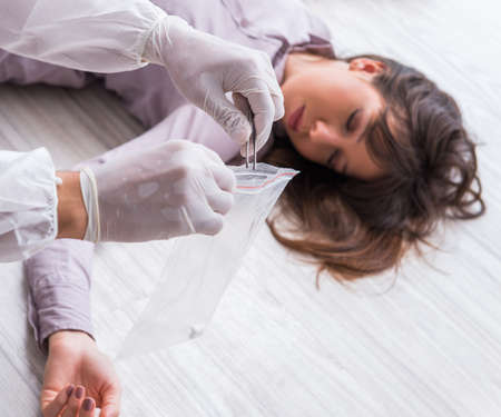 Forensic investigator at the crime scene investigating woman murの写真素材
