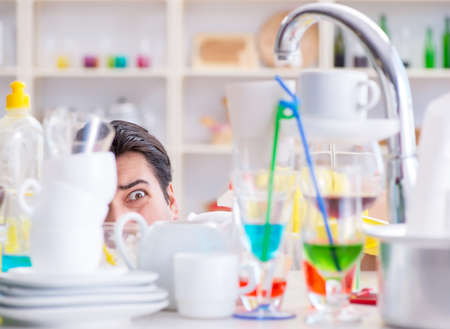 Man frustrated at having to wash dishesの写真素材