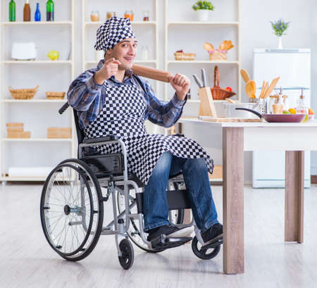 Young cook with roller preparing dough mealの写真素材