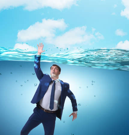 Drowning businessman in insolvency and bankruptcy conceptの写真素材