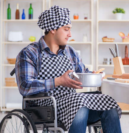 Disabled man preparing soup at kitchenの写真素材