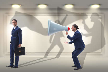 Businessman shouting through large loudspeakerの写真素材