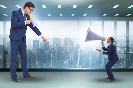 Businessman shouting through large loudspeakerの写真素材