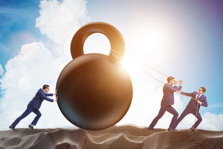 Businessmen trying to deal with difficult taskの写真素材