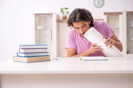 Young male architect student preparing for exams at homeの写真素材
