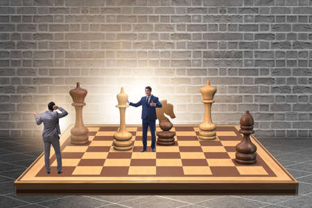 Businessman in large chess board in strategy conceptの写真素材