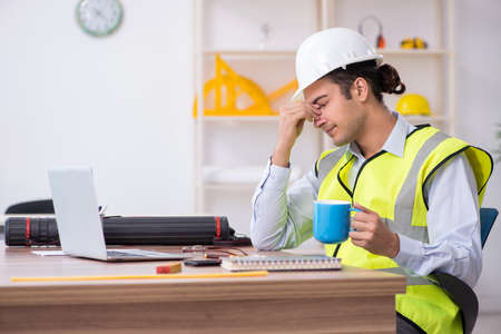 Young male architect working in the office